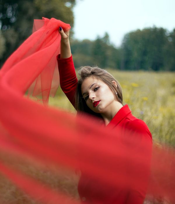 Person looking serene and confident with abstract iris-colored light effects.